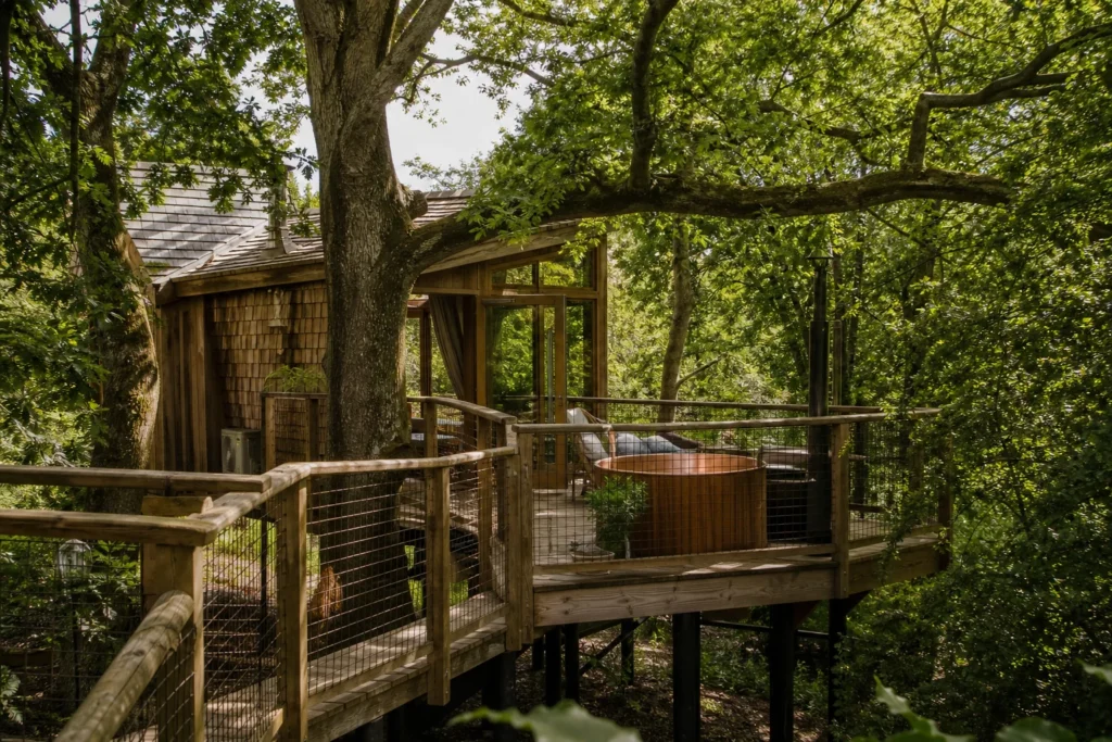 treehouse accommodation surrounded by trees at Woodsman’s Treehouse in United Kingdom